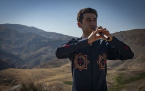 Arsen Petrosyan plays the duduk with Armenian mountains in the background.
