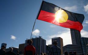An Aboriginal flag is held aloft during a Black Lives Matter protest to express solidarity with US protesters and demand an end to Aboriginal deaths in custody, in Perth on June 13, 2020.