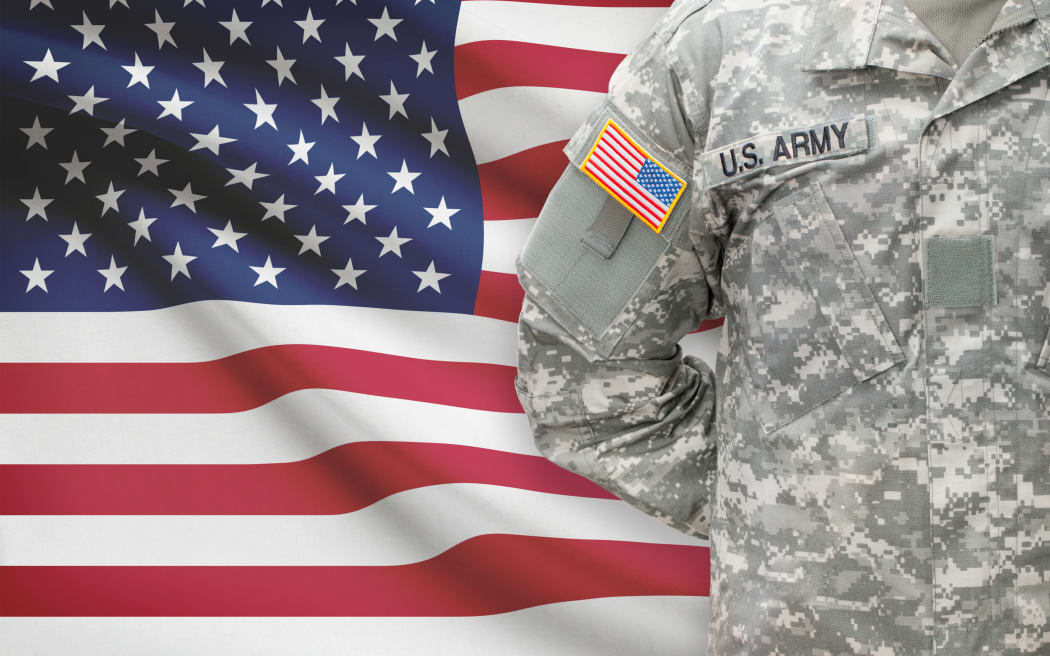 American soldier with flag on background - United States