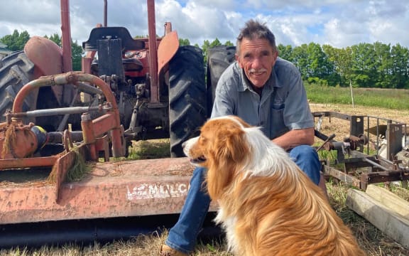 Ash Commerer at Mt Gabriel Christmas tree farm, with his dog Axel.