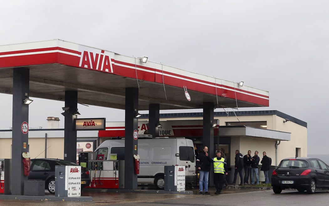 A Gendarmerie criminal identification van is parked in front of an Avia gas station in Villers-Cotterets.