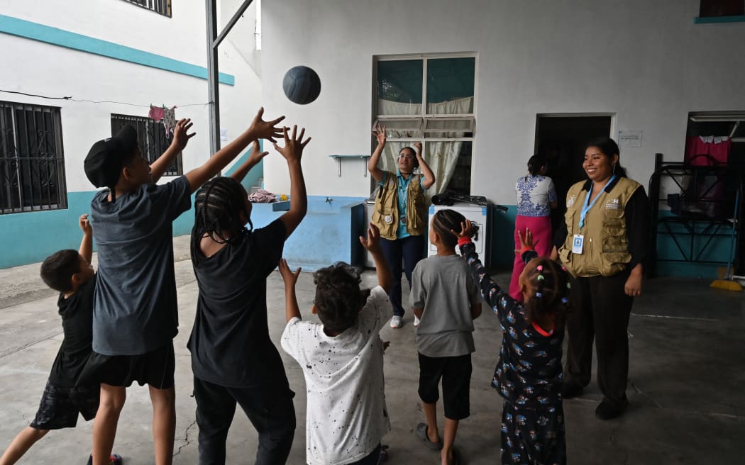 Migrant children play at the Returned Migrant Attention Centre in Tegucigalpa, Honduras on February 18, 2025. Although Central American governments say they are trying to organize reverse migration, chaos reigns. In Honduras, dozens of migrants wait at the Returned Migrant Attention Centre for an opportunity to travel to their country of origin. (Photo by Orlando SIERRA / AFP)