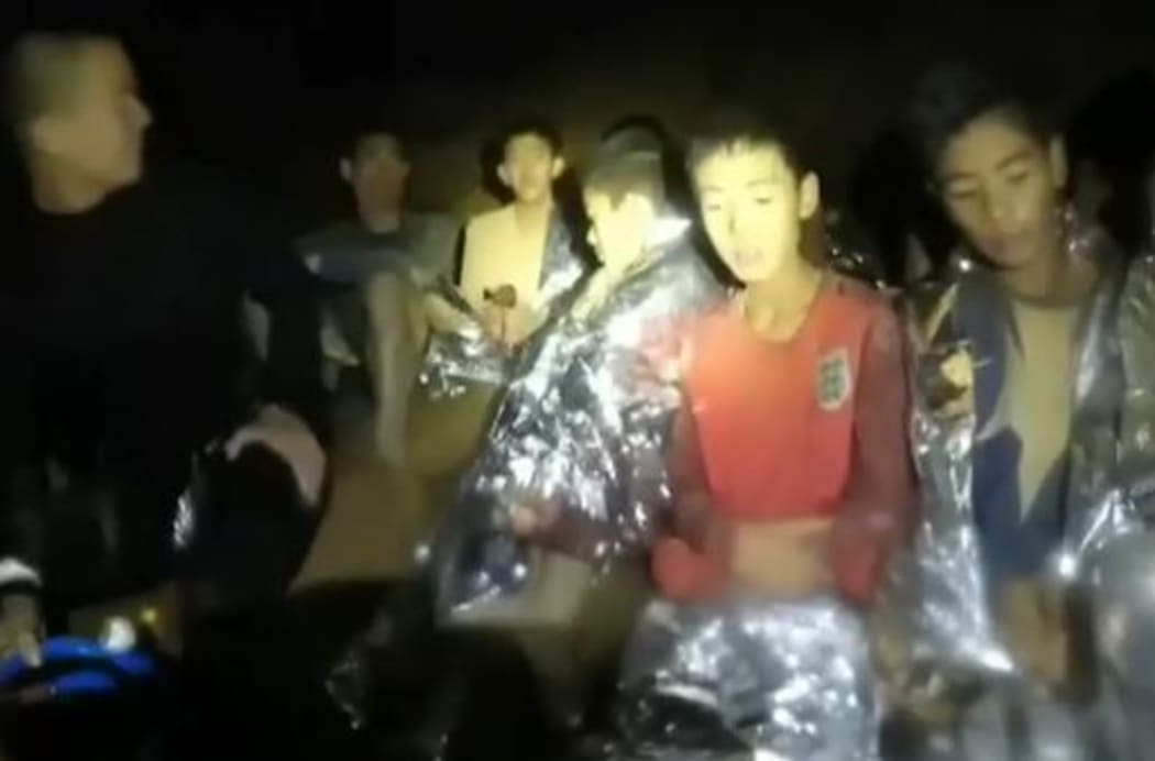 The boys can be seen introducing themselves next to a diver in a wetsuit.