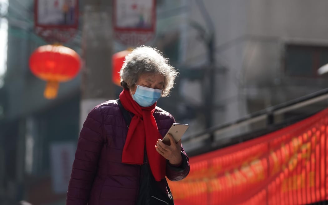 A resident checks information on her phone in Wuchang District of Wuhan, the epicenter of the novel coronavirus outbreak.