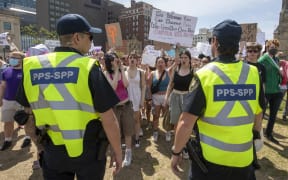 Parliamentary Protective Service officers keep pro-choice protesters separate from the pro-life protesters during the National March for Lifein Ottawa, Ontario, on May 12, 2022. - The protest comes amid a political firestorm in the United States ignited by a leaked draft opinion that showed the Supreme Court's conservative majority preparing to overturn Roe v. Wade, a landmark 1973 ruling guaranteeing abortion access nationwide. (Photo by Lars Hagberg / AFP)