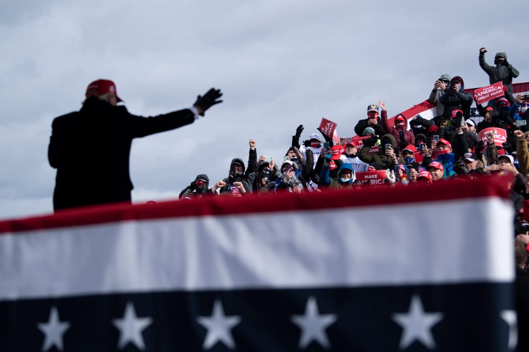 Donald Trump waves to supporters in Washington, Michigan.