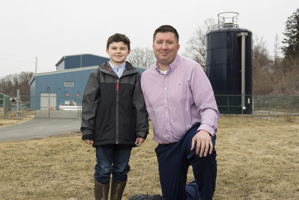 Michael Hickey and son Oliver in front of Hoosick Falls new water filtration plant.