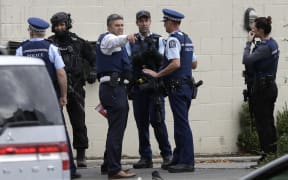 Police stand outside a mosque in central Christchurch, New Zealand, Friday, March 15, 2019.