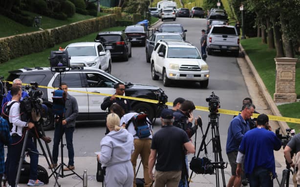 Police and members of the media gather outside the home of US producer and musician Sean “Diddy” Combs in Los Angeles on March 25, 2024.