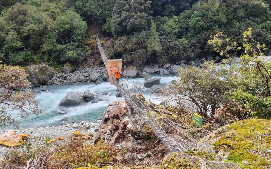 A predator free gate on a swing bridge over Scone Creek.