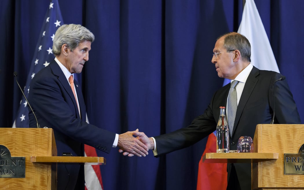 US Secretary of State John Kerry and Russian Foreign Minister Sergei Lavrov shake hands on a truce deal for Syria.
