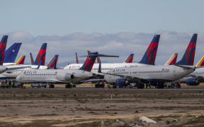 VICTORVILLE, CA - MARCH 24: Delta Air Lines jets are parked in growing numbers at Southern California Logistics Airport (SCLA) on March 24, 2020 in Victorville, California.