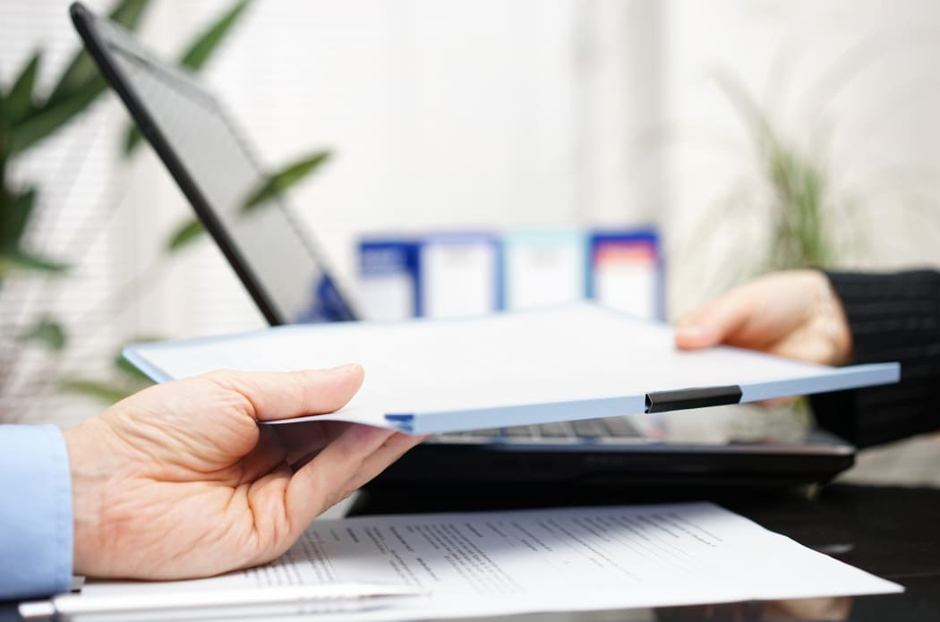 businessman and businesswoman are exchanging document or contract