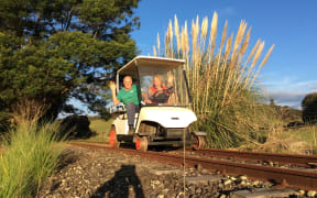 Paul and Eve Francis of Awakere Rail Adventures on a converted golf cart