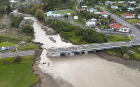 A section of the bridge in Tokomaru Bay has been wiped out by flood water, bisecting the town alongside State Highway 35