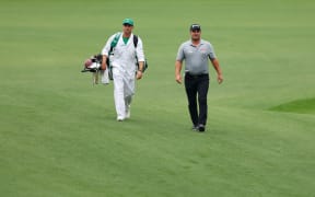 Ryan Fox of New Zealand walks up the 13th fairway with his caddie, Dean Smith, during a practice round prior to the 2023 Masters Tournament at Augusta National Golf Club.