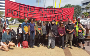 Speakers at the protest against armed police patrols.