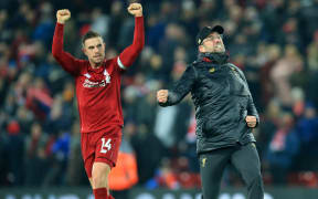 Jordan Henderson of Liverpool and Liverpool manager Jurgen Klopp react to a goal.