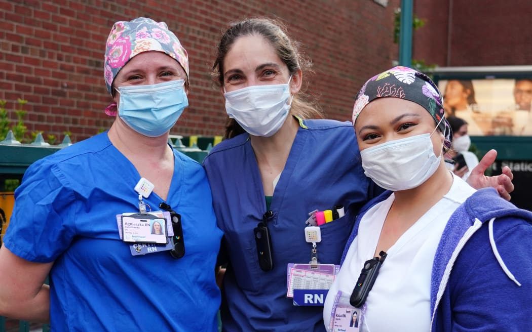 NEW YORK, NEW YORK - MAY 15: Medical workers from Lenox Hill Hospital come outside as people cheer to show gratitude to medical and frontline workers during the coronavirus pandemic on May 15, 2020 in New York City.