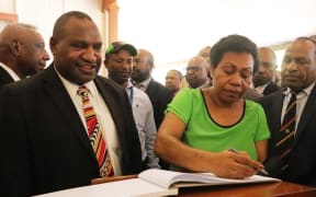 James Marape and his wife Rachael Marape signing the visitors book at Government House after arriving for his swearing in as Prime Minister of PNG.