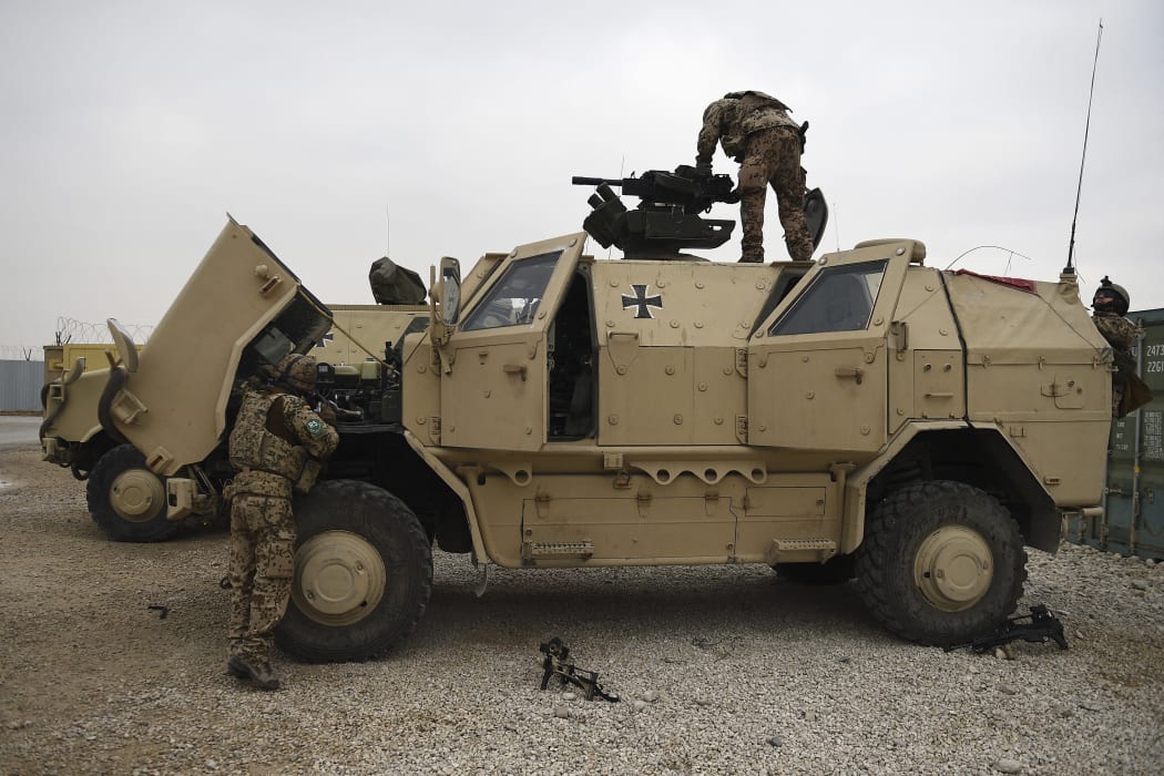 German troops work on a military vehicle at the NATO military base Camp Marmal on the outskirts of Mazar-i-Sharif on 27 November, 2019.