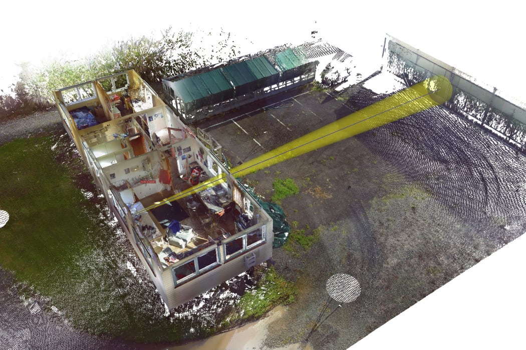 Forensic investigators plot a bullet trajectory at a crime scene.