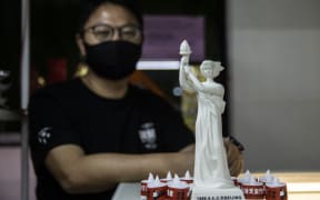 A shopkeeper with Goddess of Democracy statues like the ones hidden around a Hong Kong University on the 33rd anniversary of the Tiananmen Square massacre.