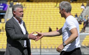 Former Wellington Phoenix coach Ufuk Talay of Sydney FC greets interim coach Chris Greenacre of the Phoenix greet each other during the round 19 A-League Men match between Wellington Phoenix and Sydney FC.