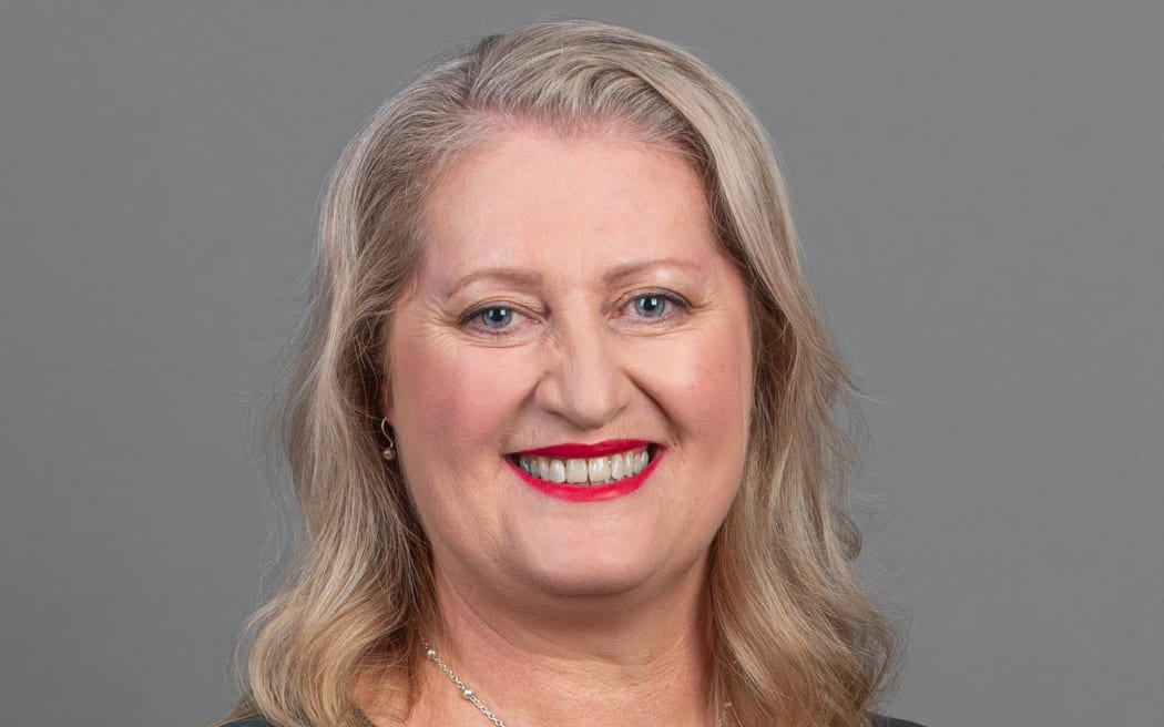 Jane Patterson smiling with grey background