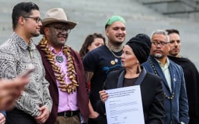 Debbie Ngarewa-Packer speaks after receiving the Dawn Raids petition.