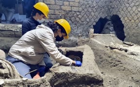 Archaeologists working in "The room of Slaves", an exceptionally well-preserved room for the slaves who worked in Villa Civita Giuliana in Pompeii.