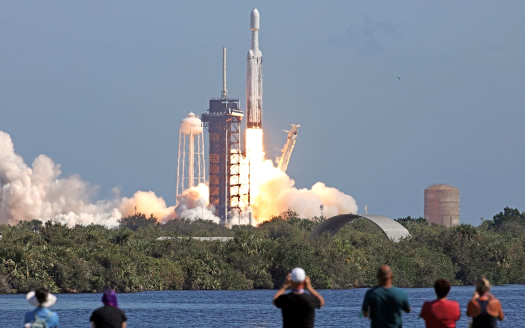 A SpaceX Falcon Heavy rocket with the Europa Clipper spacecraft aboard launches from Launch Complex 39A at NASA's Kennedy Space Center in Cape Canaveral on October 14, 2024. The spacecraft Clipper will soon launch for Jupiter's moon Europa, one of dozens of moons orbiting the Solar System’s biggest planet and the nearest spot in our celestial neighborhood that could offer a perch for life. It should reach orbit around Jupiter and Europa in 2031, where it will begin a detailed study of the moon scientists believe is covered in frozen water, which could provide a similar habitat to Earth.