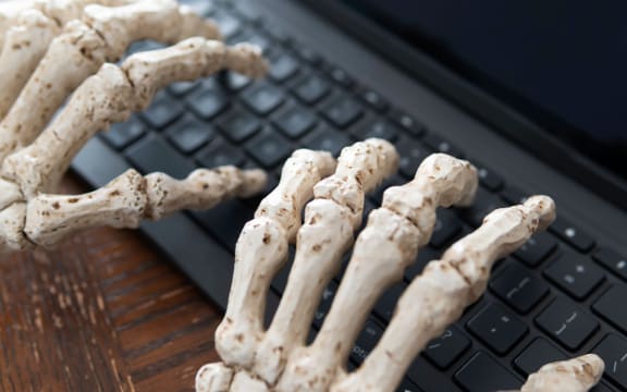 Skeleton hands typing on keyboard