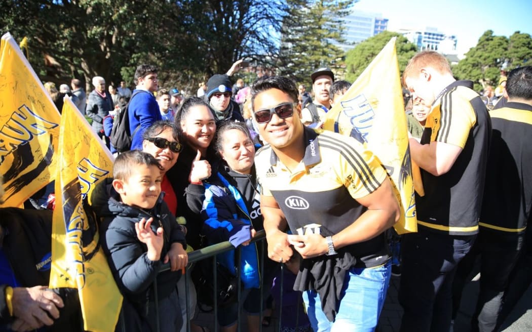 Julian Savea celebrates with fans at the team's parade through Wellington.
