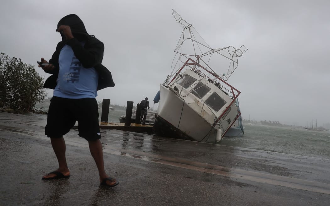 A boat is washed on shore at the Watson Island marina as Hurricane Irma passed through the area.
