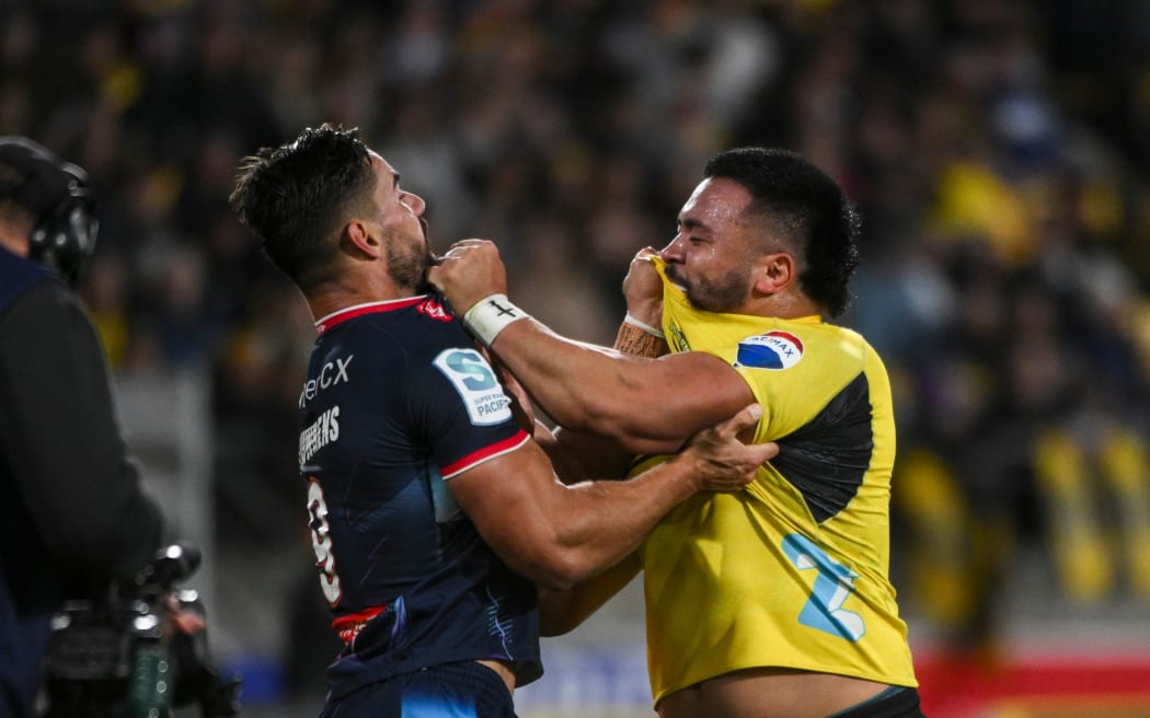Ryan Louwrens of the Melbourne Rebels and Asafo Aumua of the Hurricanes go at it.
