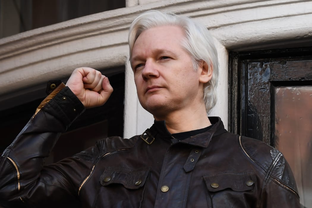 In this file photo taken on May 19, 2017 Wikileaks founder Julian Assange raises his fist prior to addressing the media on the balcony of the Embassy of Ecuador in London on May 19, 2017.