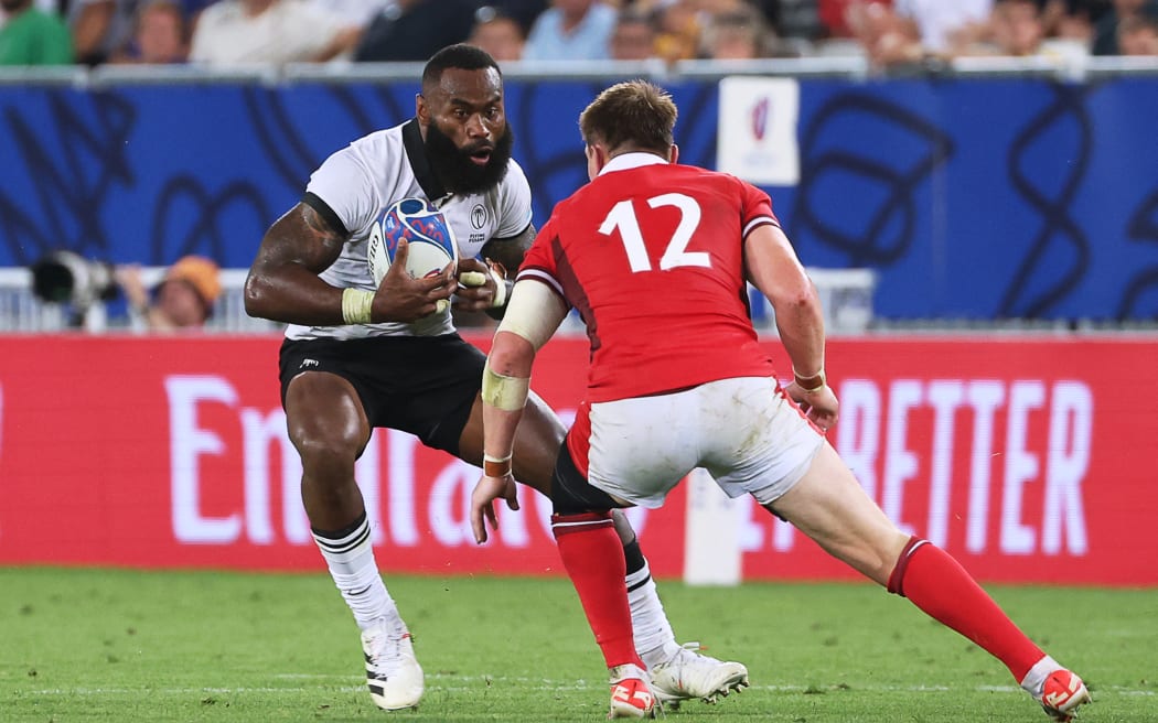 Fiji's inside centre Semi Radradra (L) runs to evade Wales' full-back Liam Williams during the France 2023 Rugby World Cup Pool C match between Wales and Fiji at Stade de Bordeaux in Bordeaux, south-western France on September 10, 2023. (Photo by ROMAIN PERROCHEAU / AFP)