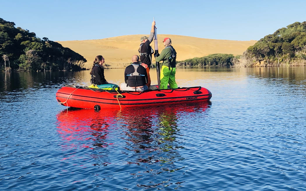 Collecting a sediment core from Lake Wai Raupo in Northland.