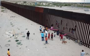 Teeter totter seesaw on the US-Mexico border wall.