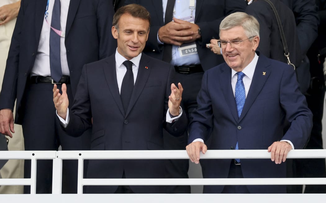 President of France Emmanuel Macron and IOC Chairman German Thomas Bach pictured during the opening ceremony of the Paris 2024 Olympic Games, at the Trocadero in Paris, France on Friday 26 July 2024. The Games of the XXXIII Olympiad are taking place in Paris from 26 July to 11 August. The Belgian delegation counts 165 athletes in 21 sports. BELGA PHOTO BENOIT DOPPAGNE BELGIUM ONLY (Photo by BENOIT DOPPAGNE / BELGA MAG / Belga via AFP)