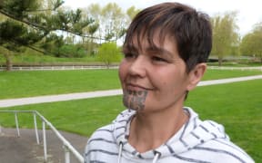 Head shot of young Marori woman with moko kauae