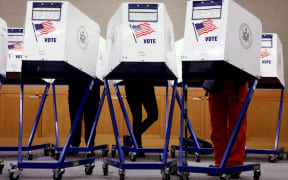 Voters fill out their ballots at a polling station in New York City on Election Day, November 5, 2024. (Photo by Leonardo Munoz / AFP)