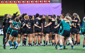 New Zealand Black Ferns form a team huddle after their defeat to Ireland.