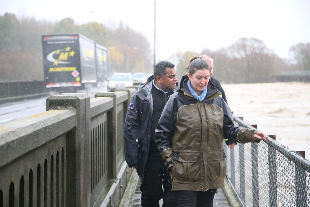 Labour Rangitata MP Jo Luxton looking at flood waters from the Ashburton State Highway 1 bridge, alongside Acting Minister for Emergency Management Kris Faafoi.