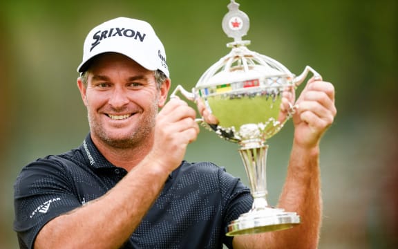 Ryan Fox of New Zealand lifts the championship trophy after winning the Canadian Open, 2025.