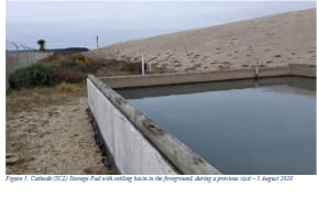 A settling pond beside the concrete pad holding 106,000 tonnes of toxic SCL waste