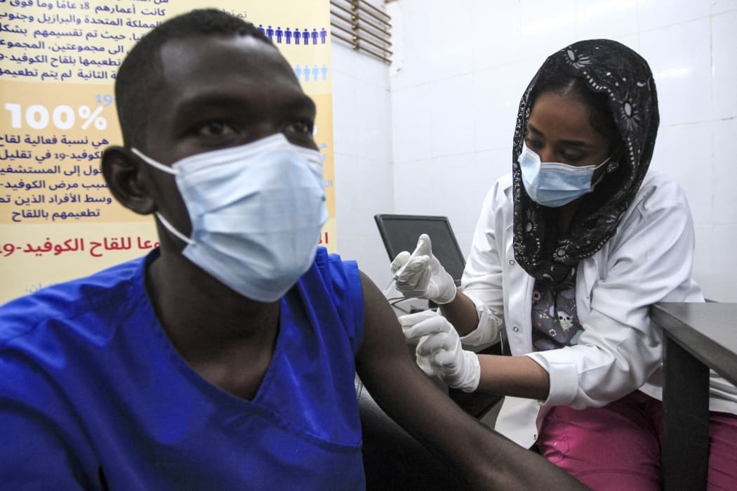 A medical worker receives a dose of the Oxford-AstraZeneca COVID-19 coronavirus vaccine at the Jabra Hospital for Emergency and Injuries in Sudan's capital Khartoum on March 9, 2021.