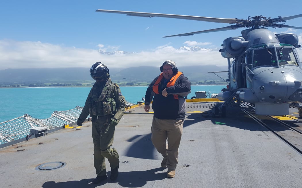 Mr Brownlee arrives on the deck of the HMCS Vancouver.