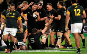 Codie Taylor is congratulated by his All Blacks team mates after scoring against Springboks in Durban 2016.
